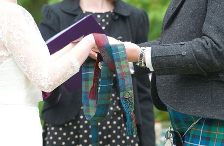 Tartan from each family, detail embroidered on each ribbon and with a ring and locket from the absent grandparents embroidered on with silk twist