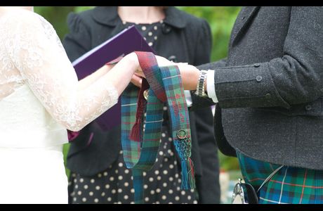 Handfasting-web-picture Tartan from each family, detail embroidered on each ribbon and with a ring and locket from the absent grandparents embroidered on with silk twist